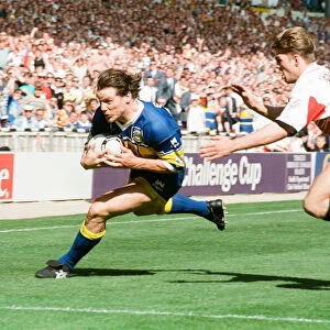 Jim Fallon avoids the Wigan defence to score a try for Leeds during the Rugby League Cup