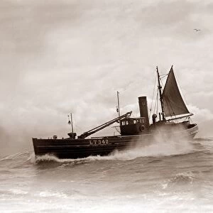 A Lowestoft Herring boat ploughing through a moderate swell in the North Sea. Circa 1935