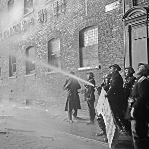 Members of the Auxiliary Fire Service and London Fire Brigade seen here fighting a fire
