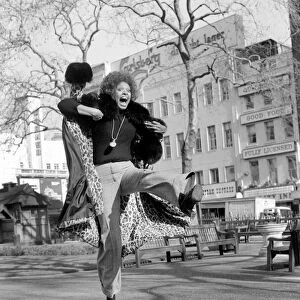 Model Lorne Lesley jumping up in the street February 1975 75-01140-001
