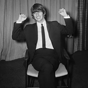 Ringo Starr sitting on chair arms raised February 1964