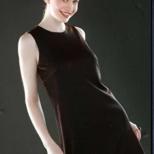 Ruth Kemmer model wearing a dark brown dress hair tied up 1996