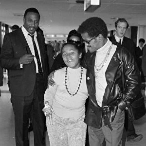 Sammy Davis Jnr arriving at Heathrow with Egey Rhodes the daughter of his band leader