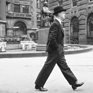 Stockbroker wearing a bowler hat seen here making his way to the Stock Exchange Circa