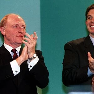 Tony Blair with Neil Kinnock clapping together