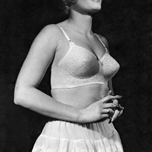 Woman wearing a bra and skirt January 1962 P018252