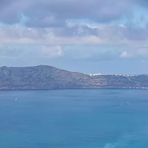 10.05.19. - Santorini, Greece: Norwegian Jade cruise ship in Santorini sea bay, Blue water with volcanic cliffs over the horizon. Luxury cruiser Fira