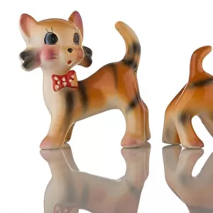 A pair of china kittens with red spotted bow ties