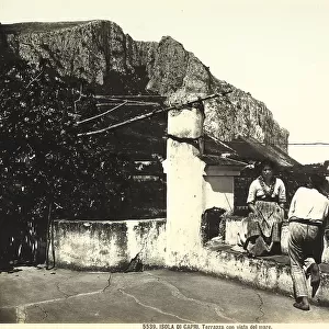 A man and a woman in traditional clothing on a panoramic terrace in Capri