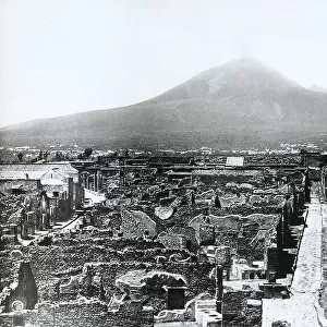 View of the Vicolo di Modesto amidst the ruins of Pompei. The Vesuvius stands out in the background