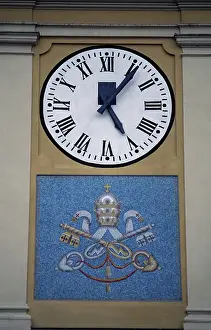 Roman Numeral Prints: Clock Tower, Boretto, Emilia-Romagna, Italy, Detail of the clock and papal coat of arms